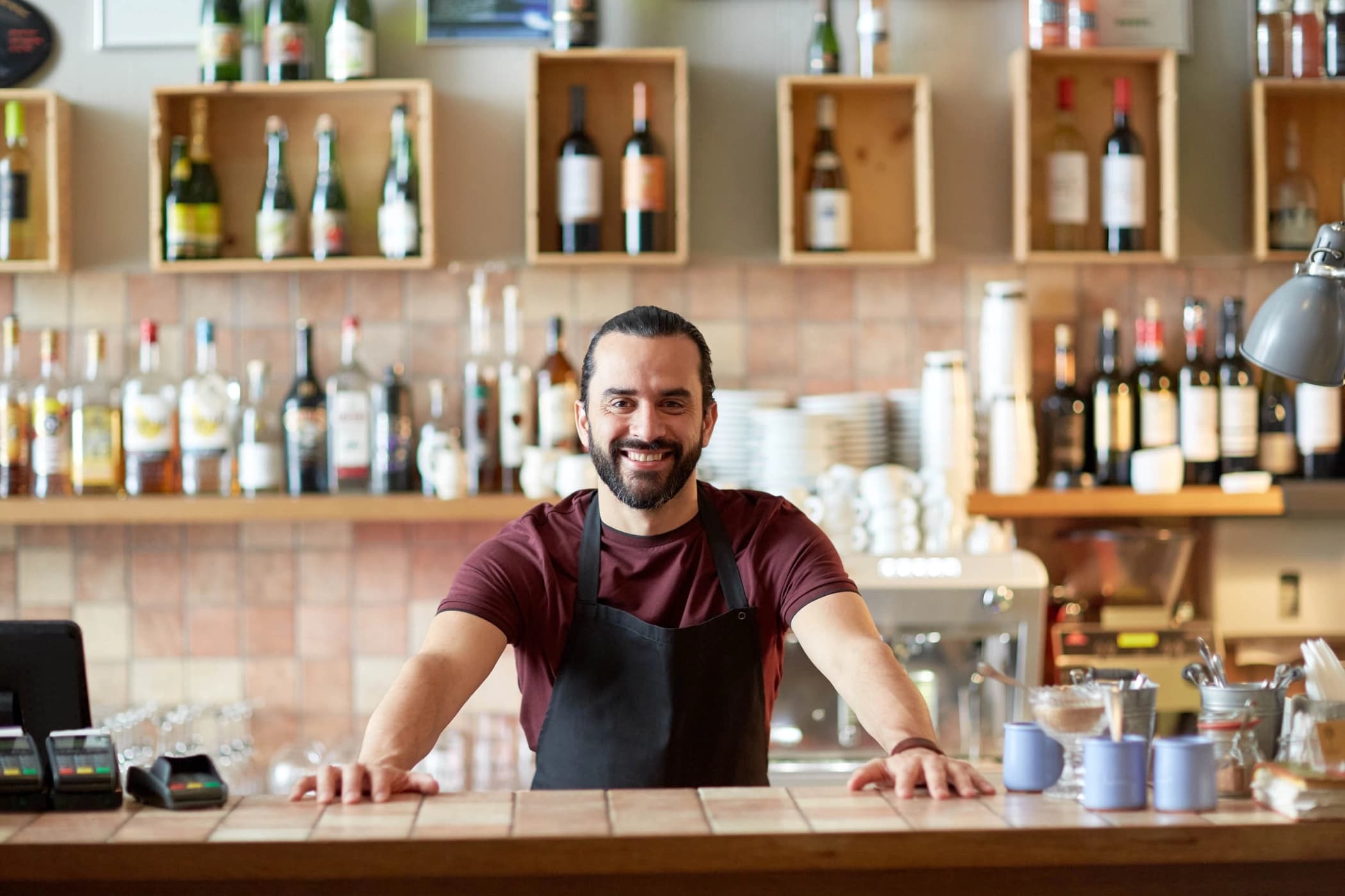 A friendly bartender greeting customers at the bar